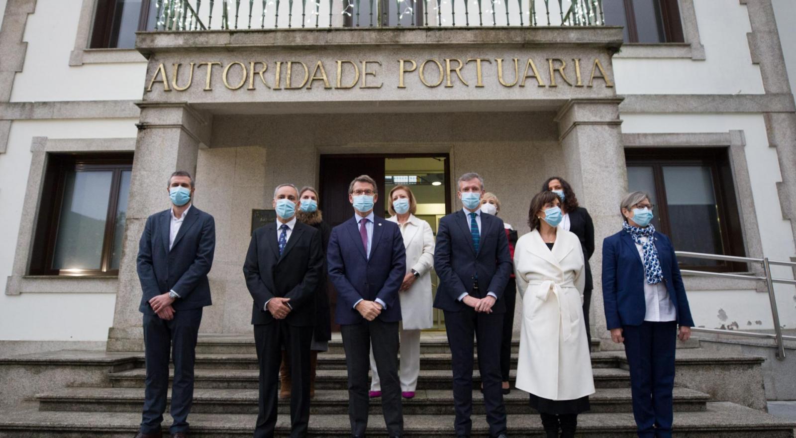 El presidente y las autoridades participantes en su toma de posesión posan frente a la fachada de la Autoridad Portuaria de Vilagarcía